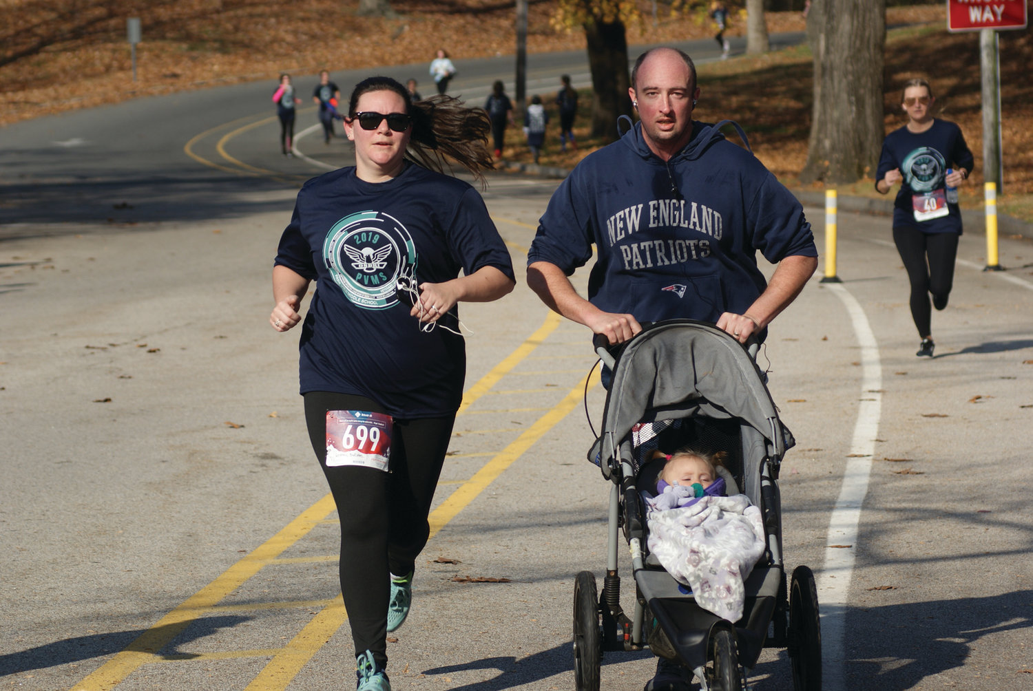 TAKING IT IN STRIDE: Matt and Lindsay Ryan of Warwick kept pace as they were joined by their daughter, 10-month-old Lillian. The family finished the course in just less than 40 minutes.